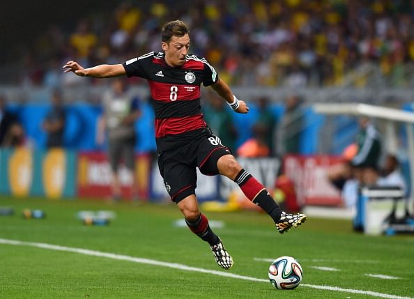 Germany's Mesut Ozil comforts Brazilian fans after 7-1 defeat in World Cup semi-final