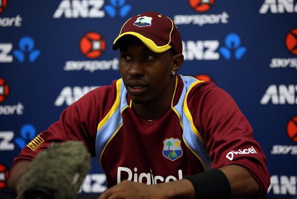 West Indian players stand behind captain Dwayne Bravo at toss before 4th ODI
