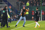 A pitch invader provokes Franck Ribery after hitting him with a scarf.