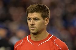 Liverpool captain Steven Gerrard shows Mario Balotelli when to swap shirts