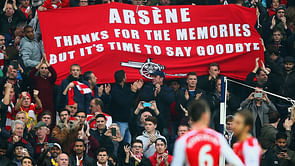 Arsene Wenger reacts to Arsenal fans' banner after the West Brom win