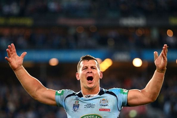 Australian rugby player urinates in public close to police car