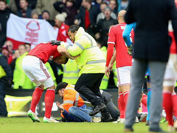 Video: Derby fan invades pitch and throws punch at Nottingham forest player after their loss