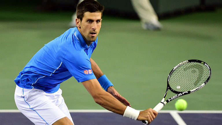 Novak Djokovic plays tennis with his fan