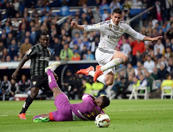 Real Madrid beat Malaga to keep the heat on Barcelona