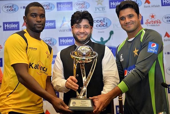 Captains Elton Chigumbura (L) and Azhar Ali (R) pose with the ODI series trophy