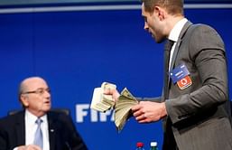 English comedian Simon Brodkin showers fake notes on FIFA chief Sepp Blatter