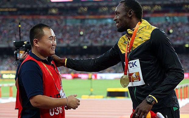 Usain Bolt receives gift from the cameraman who took him out during his 200m victory celebration