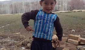 Boy wearing Lionel Messi shirt made of plastic bag found in Afghanistan