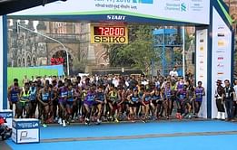 Runners show their unhappiness over the crowded lanes in Mumbai Marathon