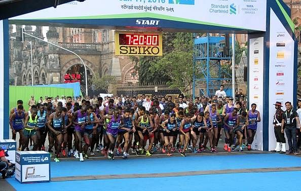 Runners show their unhappiness over the crowded lanes in Mumbai Marathon