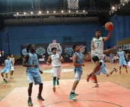 Yashas Ramesh (in white) of Bengaluru Beast drives in for the layup against Hyderabad Sky (in blue)