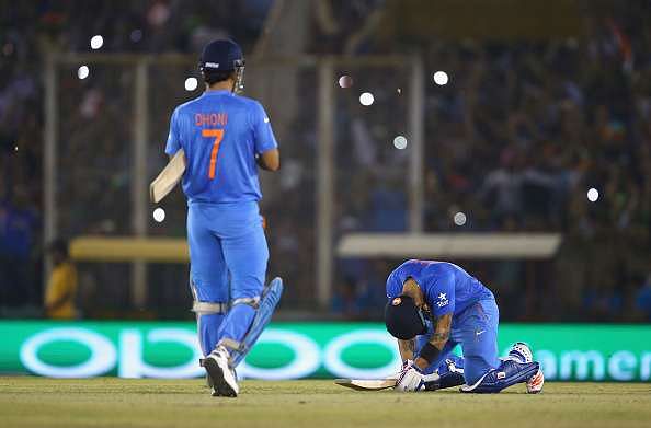 Virat Kohli goes down on the ground after MS Dhoni hit the winning runs against Australia