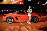 Kerber poses with the Porsche car that she was presented with