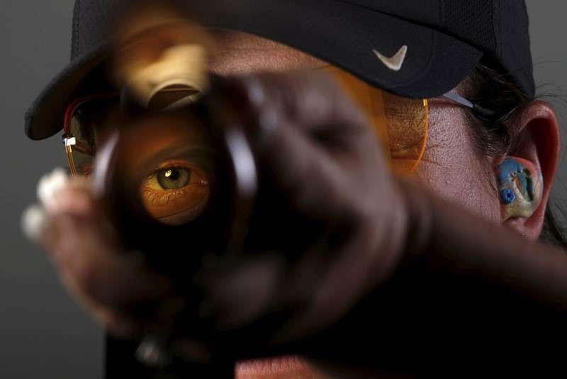 Shooting competitor Kim Rhode looks down the barrel of her shotgun as she poses for a portrait at the U.S. Olympic Committee Media Summit in Beverly Hills, Los Angeles, California March 8, 2016. REUTERS/Lucy Nicholson - RTS9XEX