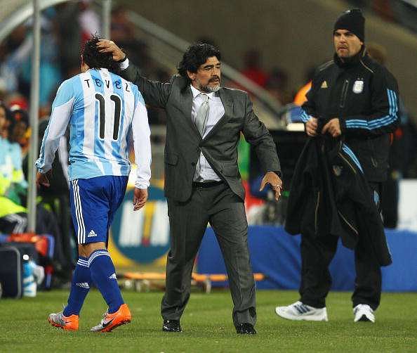 JOHANNESBURG, SOUTH AFRICA - JUNE 27:  Diego Maradona head coach of Argentina substitutes double goal scorer Carlos Tevez during the 2010 FIFA World Cup South Africa Round of Sixteen match between Argentina and Mexico at Soccer City Stadium on June 27, 2010 in Johannesburg, South Africa.  (Photo by Richard Heathcote/Getty Images)
