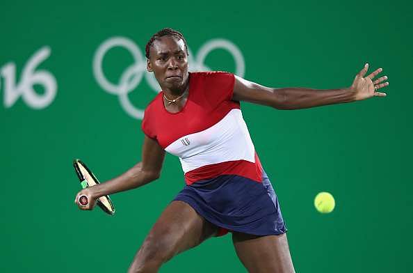 RIO DE JANEIRO, BRAZIL - AUGUST 06:  Venus Williams of USA in action against Kirsten Flipkens of Belgium in the women&#039;s first round on Day 1 of the Rio 2016 Olympic Games at the Olympic Tennis Centre on August 6, 2016 in Rio de Janeiro, Brazil.  (Photo by Julian Finney/Getty Images)