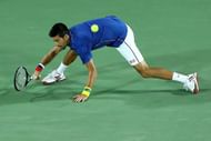 RIO DE JANEIRO, BRAZIL - AUGUST 07: Novak Djokovic of Serbia stretches for a forehand against Juan Martin Del Potro of Argentina in their singles match on Day 2 of the Rio 2016 Olympic Games at the Olympic Tennis Centre on August 7, 2016 in Rio de Janeiro, Brazil. (Photo by Cameron Spencer/Getty Images)