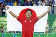RIO DE JANEIRO, BRAZIL - AUGUST 14: (EDITORS NOTE: Retransmission with alternate crop.) Kei Nishikori of Japan celebrates with the Japanese flag after winning the singles bronze medal match against Rafael Nadal of Spain on Day 9 of the Rio 2016 Olympic Games at the Olympic Tennis Centre on August 14, 2016 in Rio de Janeiro, Brazil. (Photo by Julian Finney/Getty Images)