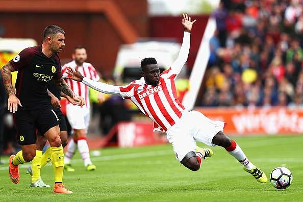STOKE ON TRENT, ENGLAND - AUGUST 20: Mame Biram Diouf of Stoke City falls the floor after being challenged during the Premier League match between Stoke City and Manchester City at Bet365 Stadium on August 20, 2016 in Stoke on Trent, England.  (Photo by Michael Steele/Getty Images)