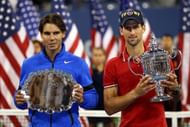 NEW YORK, NY - SEPTEMBER 12: Novak Djokovic of Serbia holds up the winner's the trophy as Rafael Nadal (L) of Spain holds up the runner up award after Djokovic defeated Nadal during the Men's Final on Day Fifteen of the 2011 US Open at the USTA Billie Jean King National Tennis Center on September 12, 2011 in the Flushing neighborhood of the Queens borough of New York City. (Photo by Clive Brunskill/Getty Images)