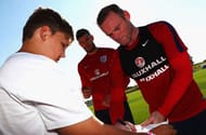 BURTON-UPON-TRENT, ENGLAND - AUGUST 30: Wayne Rooney and Fraser Forster of England sign autographs during an England training session at St George's Park on August 30, 2016 in Burton-upon-Trent, England. (Photo by Matthew Lewis/Getty Images)