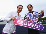 EASTBOURNE, ENGLAND - JUNE 23: Martina Hingis of Switzerland and Sania Mirza of India hold a road to Singapore sign on day five of the WTA Aegon International at Devonshire Park on June 23, 2016 in Eastbourne, England. (Photo by Steve Bardens/Getty Images for LTA)