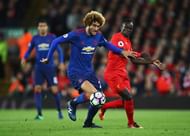 LIVERPOOL, ENGLAND - OCTOBER 17: Sadio Mane of Liverpool challenges Marouane Fellaini of Manchester United during the Premier League match between Liverpool and Manchester United at Anfield on October 17, 2016 in Liverpool, England. (Photo by Clive Brunskill/Getty Images)