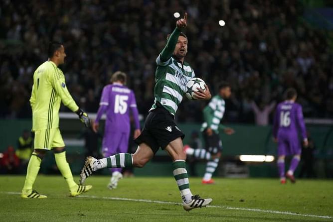 Late Benzema header gives Real 2-1 win at 10-man Sporting