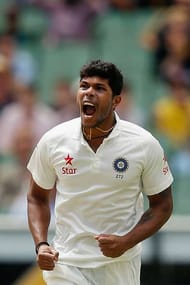 MELBOURNE, AUSTRALIA - DECEMBER 29: Umesh Yadav of India celebrates taking the wicket of Steve Smith of Australia during day four of the Third Test match between Australia and India at Melbourne Cricket Ground on December 29, 2014 in Melbourne, Australia.. (Photo by Darrian Traynor/Getty Images)