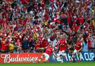 LONDON, ENGLAND - MAY 17: (L-R) Aaron Ramsey of Arsenal celebrates with Kieran Gibbs and Jack Wilshere as he scores their third goal during the FA Cup with Budweiser Final match between Arsenal and Hull City at Wembley Stadium on May 17, 2014 in London, England. (Photo by Paul Gilham/Getty Images)