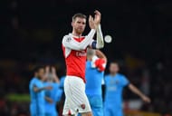 LONDON, ENGLAND - FEBRUARY 23: A dejected Per Mertesacker of Arsenal applauds the home fans following their team's 2-0 defeat during the UEFA Champions League round of 16, first leg match between Arsenal FC and FC Barcelona at the Emirates Stadium on February 23, 2016 in London, United Kingdom. (Photo by Shaun Botterill/Getty Images)