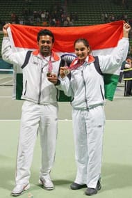 DOHA, QATAR - DECEMBER 13: Leander Paes (L) and Sania Mirza of India pose with the gold medal after the Mixed Doubles Final against Satoshi Iwabuchi and Akiko Morigami of Japan during the 15th Asian Games Doha 2006 at the Khalifa International Tennis and Squash Complex on December 13, 2006 in Doha, Qatar. (Photo by Julian Finney/Getty Images for DAGOC)