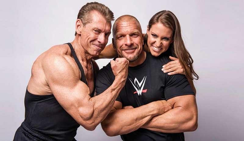 Triple H with Vince McMahon (L) and Stephanie McMahon (R)