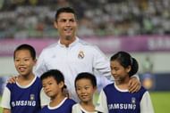 GUANGZHOU, CHINA - JULY 27: Cristiano Ronaldo of Real Madrid poses with the ball kids during the match of International Champions Cup China 2015 between Real Madrid and FC Internazionale at Tianhe Stadium on July 27, 2015 in Guangzhou, China. (Photo by Zhong Zhi/Getty Images)