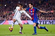 BARCELONA, SPAIN - DECEMBER 03: Mariano (L) of Real Madrid CF and Sergio Busquets (R) of FC Barcelona fight for the ball during the La Liga match between FC Barcelona and Real Madrid CF at Camp Nou stadium on December 3, 2016 in Barcelona, Spain. (Photo by Alex Caparros/Getty Images)