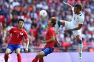 LONDON, ENGLAND - AUGUST 01: Seokho Hwang (C) of Korea Republic is challenged by Pierre Aubameyang (R) of Gabon during the Men's Football first round Group B Match between Korea Republic and Gabon on Day 5 of the London 2012 Olympic Games at Wembley Stadium on August 1, 2012 in London, England. (Photo by Michael Steele/Getty Images)
