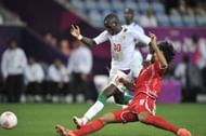 COVENTRY, UNITED KINGDOM - AUGUST 1: Hamdam Al-Kamali of United Arab Emirates fighting for the ball against Sadio Mane of Senegal during the Men's Football first round Group A Match between Senegal and United Arab Emirates, on Day 5 of the London 2012 Olympic Games at City of Coventry Stadium on August 1, 2012 in Coventry, England. (Photo by Francis Bompard/Getty Images)
