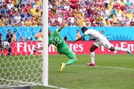 BRASILIA, BRAZIL - JUNE 26: Asamoah Gyan of Ghana scores his team's first goal past goalkeeper Beto of Portugal during the 2014 FIFA World Cup Brazil Group G match between Portugal and Ghana at Estadio Nacional on June 26, 2014 in Brasilia, Brazil. (Photo by Adam Pretty/Getty Images)