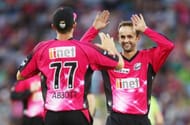 SYDNEY, AUSTRALIA - JANUARY 25: Sean Abbott of the Sixers celebrates with team mate Nathan Lyon after taking a catch to dismiss Mike Hussey of the Thunder during the Big Bash League match between Sydney Thunder and the Sydney Sixers at ANZ Stadium on January 25, 2014 in Sydney, Australia. (Photo by Mark Metcalfe/Getty Images)