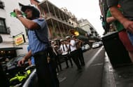 NEW ORLEANS, LA - AUGUST 21: A city police officer stands by as members of the Hacienda Brass Band perform for a bachelor party in the famed French Quarter, a magnet for tourists, on August 21, 2015 in New Orleans, Louisiana. The tourism industry has rebounded strongly in the city following Katrina and last year the city had nearly as many visitors as the year before the storm. The tenth anniversary of Hurricane Katrina, which killed at least 1836 and is considered the costliest natural disaster in U.S. history, is August 29. (Photo by Mario Tama/Getty Images)