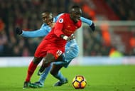 LIVERPOOL, ENGLAND - DECEMBER 27: Sadio Mane of Liverpool evades Gianelli Imbula of Stoke City during the Premier League match between Liverpool and Stoke City at Anfield on December 27, 2016 in Liverpool, England. (Photo by Alex Livesey/Getty Images)