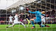 SWANSEA, WALES - JANUARY 14: Olivier Giroud (c) strokes in the first Arsenal goal past Lukasz Fabianski during the Premier League match between Swansea City and Arsenal at Liberty Stadium on January 14, 2017 in Swansea, Wales. (Photo by Stu Forster/Getty Images)