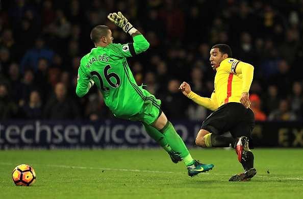 WATFORD, ENGLAND - JANUARY 14: Troy Deeney of Watford (R) shoots and Victor Valdes of Middlesbrough (L) attempts to save during the Premier League match between Watford and Middlesbrough at Vicarage Road on January 14, 2017 in Watford, England.  (Photo by Richard Heathcote/Getty Images)