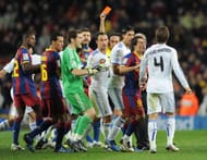 BARCELONA, SPAIN - NOVEMBER 29: Goalkeeper Iker Casillas (C) of Real Madrid and Bojan Krkic (2nd R) of Barcelona react to Sergio Ramos (R) of Real Madrid as he receives a red card from referee Eduardo Iturralde during the la liga match between Barcelona and Real Madrid at the Camp Nou stadium on November 29, 2010 in Barcelona, Spain. (Photo by Jasper Juinen/Getty Images)