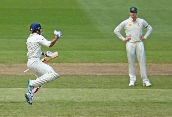MELBOURNE, AUSTRALIA - DECEMBER 28: Virat Kohli (L) of India leaps as he celebrates after reaching his century as Steven Smith of Australia looks on during day three of the Third Test match between Australia and India at Melbourne Cricket Ground on December 28, 2014 in Melbourne, Australia. (Photo by Scott Barbour/Getty Images)