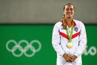 RIO DE JANEIRO, BRAZIL - AUGUST 13: Gold medalist Monica Puig of Puerto Rico reacts during the medal ceremony for Women's Singles on Day 8 of the Rio 2016 Olympic Games at the Olympic Tennis Centre on August 13, 2016 in Rio de Janeiro, Brazil. (Photo by Clive Brunskill/Getty Images)