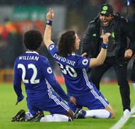 LIVERPOOL, ENGLAND - JANUARY 31: David Luiz (C) of Chelsea celebrates scoring the opening goal with his team mate Willian (L) and manager Antonio Conte (R) during the Premier League match between Liverpool and Chelsea at Anfield on January 31, 2017 in Liverpool, England. (Photo by Clive Mason/Getty Images)
