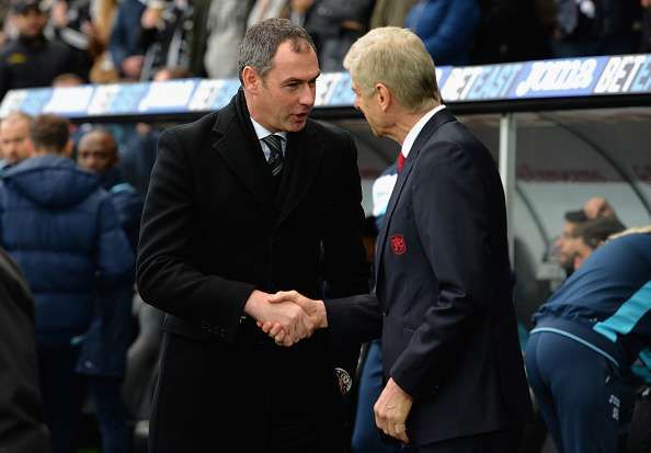 SWANSEA, WALES - JANUARY 14: Paul Clement, Manager of Swansea City shakes hands with Arsene Wenger, Manager of Arsenal during the Premier League match between Swansea City and Arsenal at Liberty Stadium on January 14, 2017 in Swansea, Wales. (Photo by Tony Marshall/Getty Images)