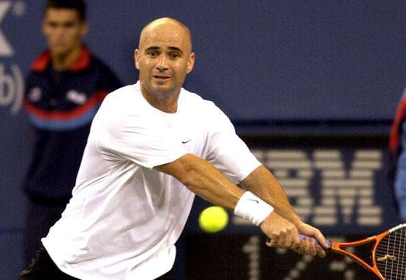 Andre Agassi returns a backhand during the first set Tuesday, September 2, 2003  at the U. S. Open in New York.  Agassi, top ranked in the men's division, dropped the first set to Taylor Dent in a match that was twice delayed by rain. (Photo by A. Messerschmidt/Getty Images)